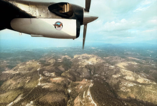 View past the propeller of a Twin Otter turboprop over the Guatemalan highlands, on the flight from Guatemala City to Huehuetenango.