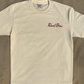 Front of the ivory Rival Bros Lakeside FREEZO Tee with red Rival Bros script on the chest