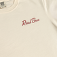 Close-up of the red Rival Bros script and Comfort Colors label on the ivory Lakeside FREEZO Tee