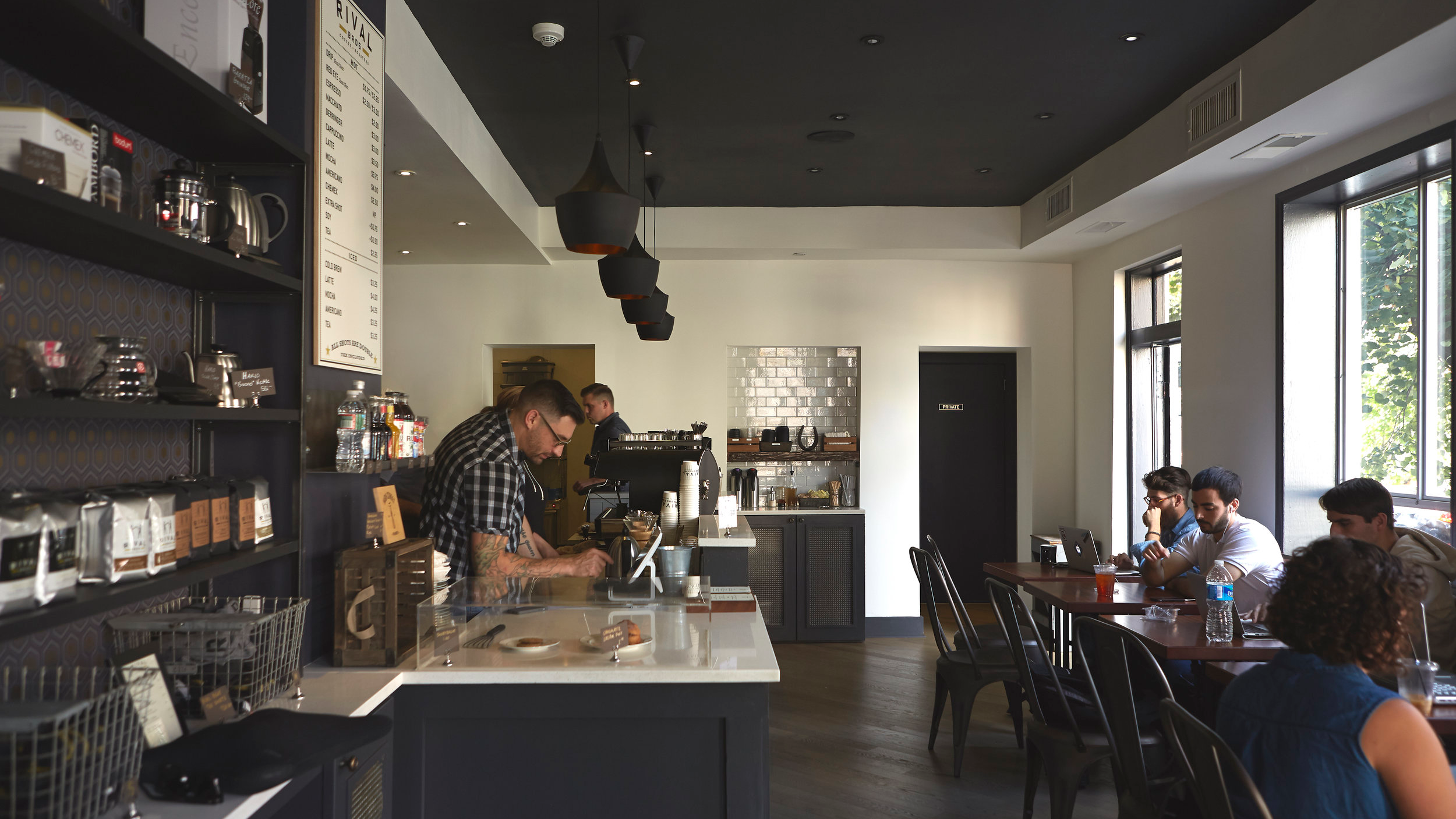 Owner, Damien P., working Rival Bros coffee bar