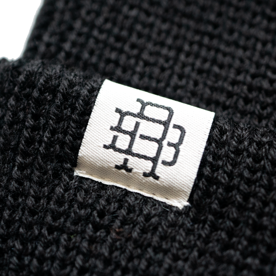 close up view of logo on black Rival Bros wool beanie